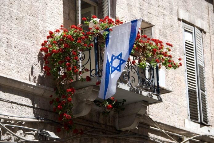 Flag of Isreal hanging on a balcony in Jerusale